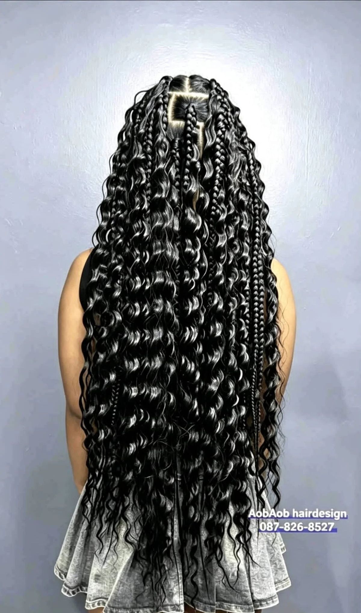 Long boho braids with curly ends, back view